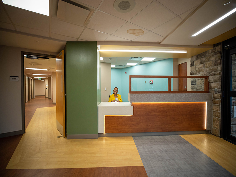 A reception desk with the receptionist at StoneCrest Center